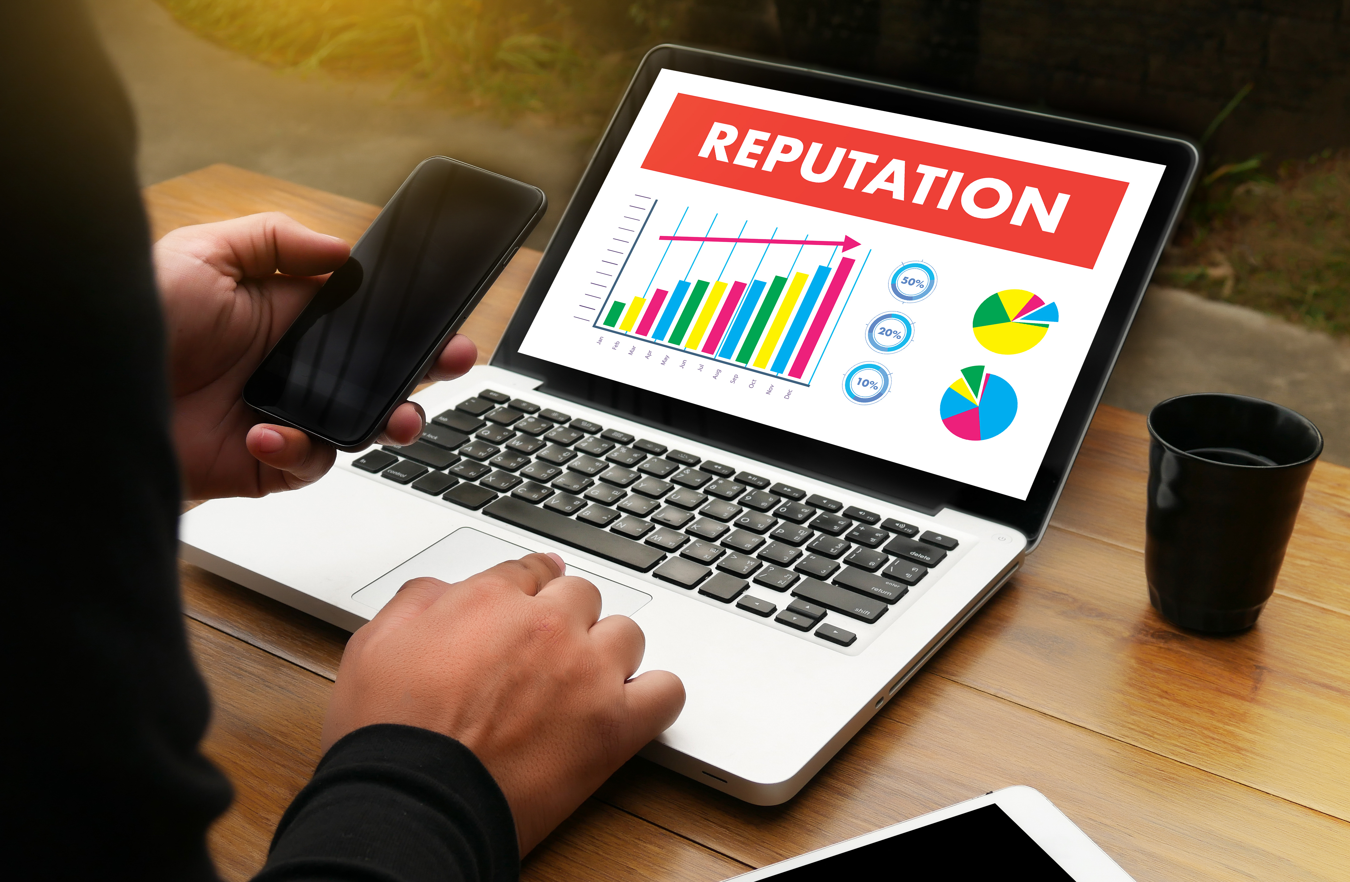 A laptop displaying a reputation graph and chart.